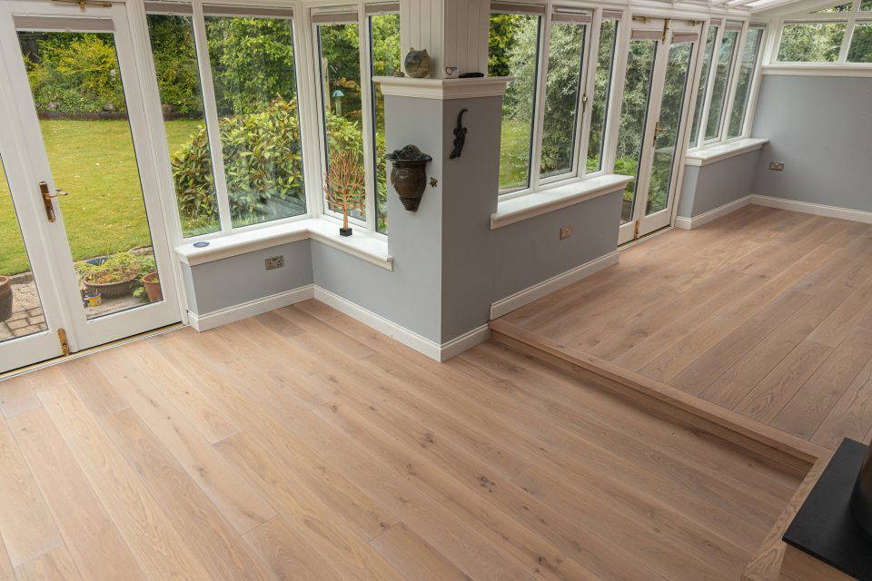 Engineered oak flooring installation in Edinburgh conservatory with large garden windows by Rocks Property Restoration